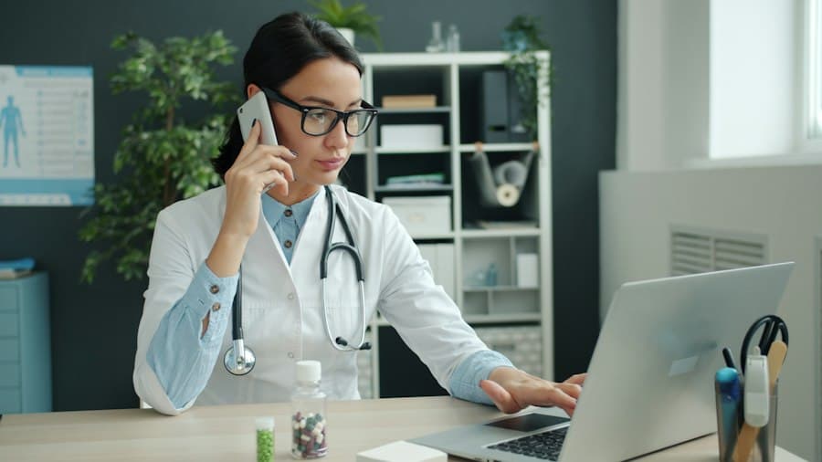 Physician reviewing records on a laptop